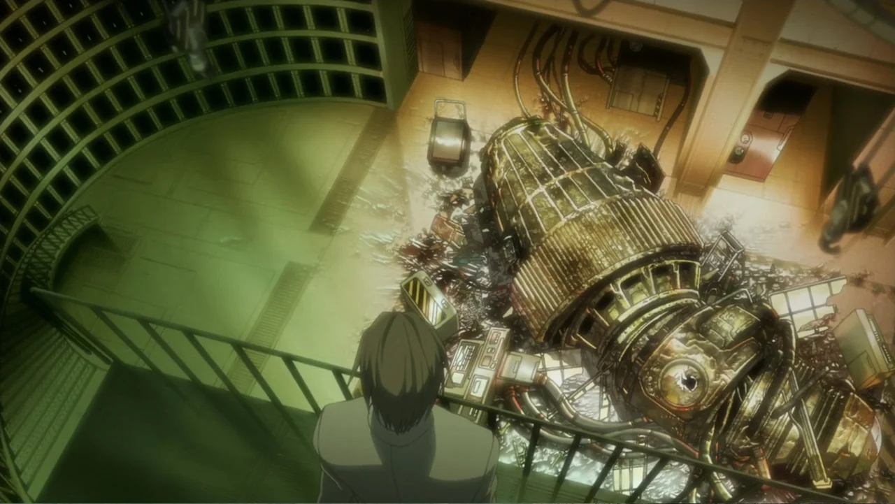 Batman: Gotham Knight (2008) movie still: wide — A dark industrial interior with green illumination features a large wrecked mechanical object…