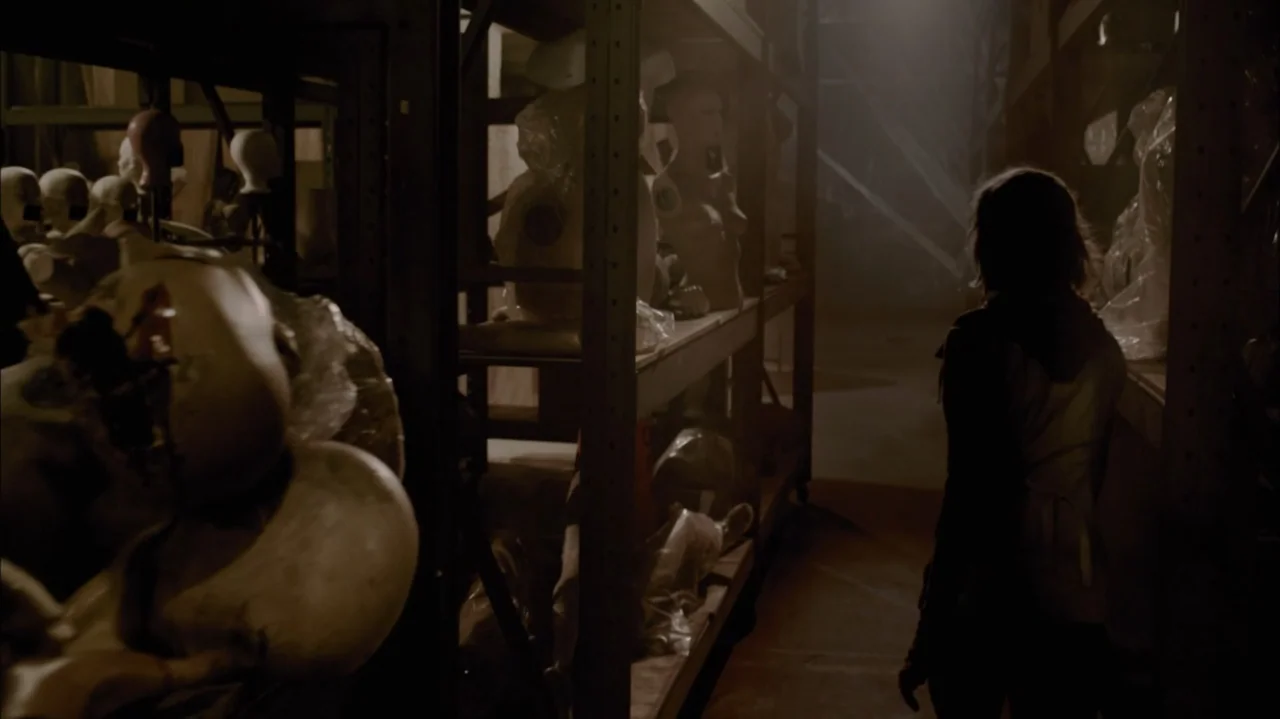 Silent Hill: Revelation 3D (2012) movie still: medium — A dimly lit storage room features tall metal shelves packed with various plastic mannequin…