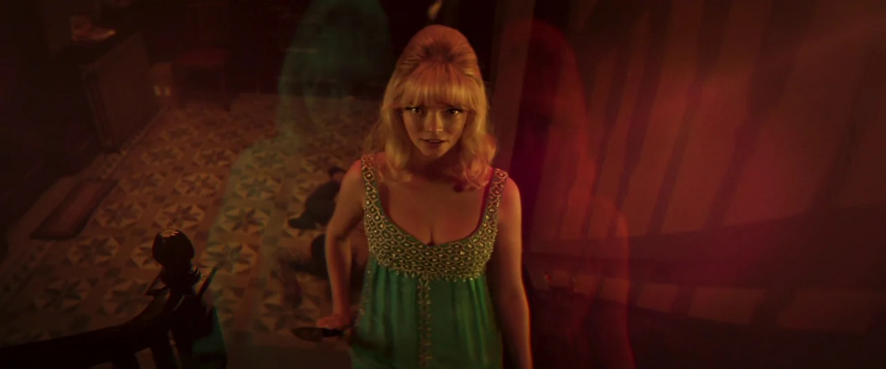 Last Night in Soho (2021) movie still: medium — A woman stands on a floor with patterned tiling at the bottom of a staircase. She holds a small…