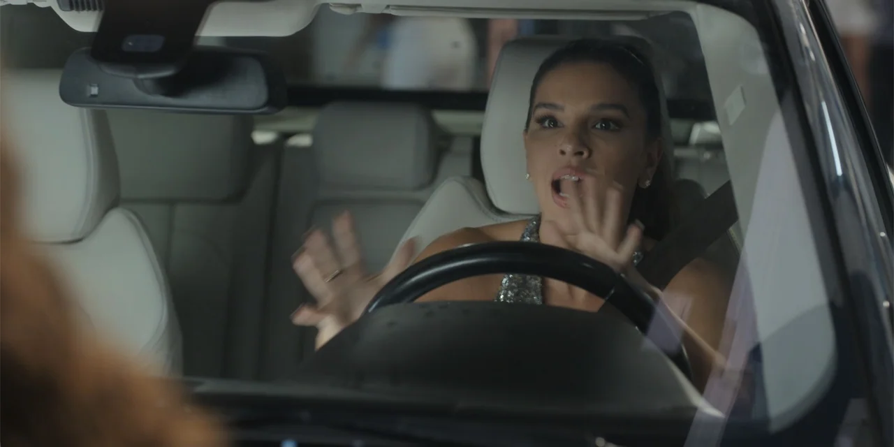 An Unforgettable Year - Summer (2023) movie still: medium — The interior of a modern car with light-colored leather seats and a dashboard. A woman…