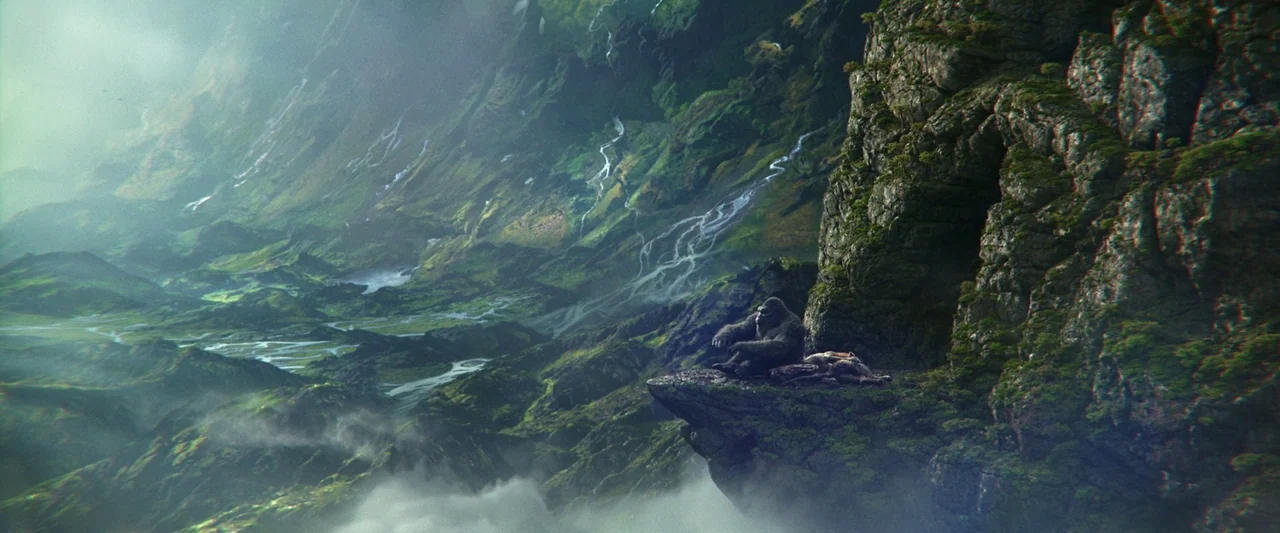 Godzilla x Kong: The New Empire (2024) movie still: wide — A vast, lush green valley is filled with streams and low-hanging mist. A large gorilla…