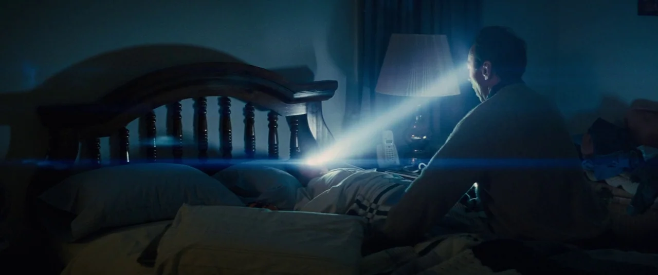 Midnight Special (2016) movie still: medium — A dark bedroom features a wooden bed frame with a sleeping person tucked under sheets. An older man…