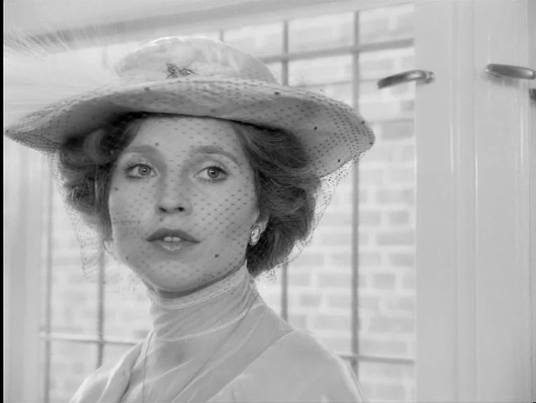 Effi Briest (1974) movie still: closeup — A light-filled interior space features a large window with white muntins and metal hardware. A young woman…