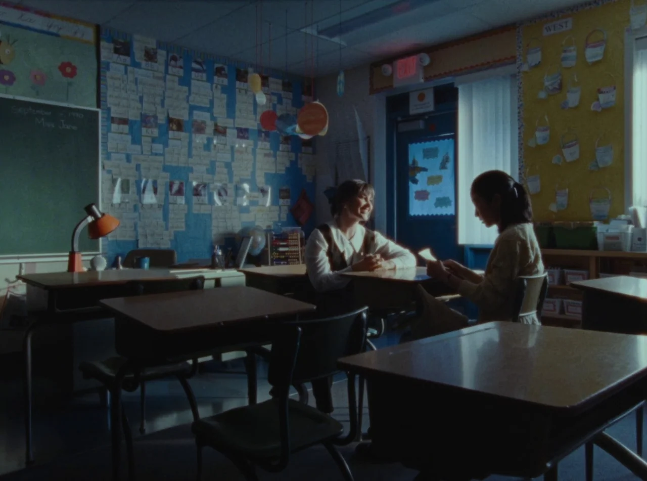 Riceboy Sleeps (2022) movie still: wide — An elementary school classroom features decorated walls with charts, alphabet displays, and hanging model…