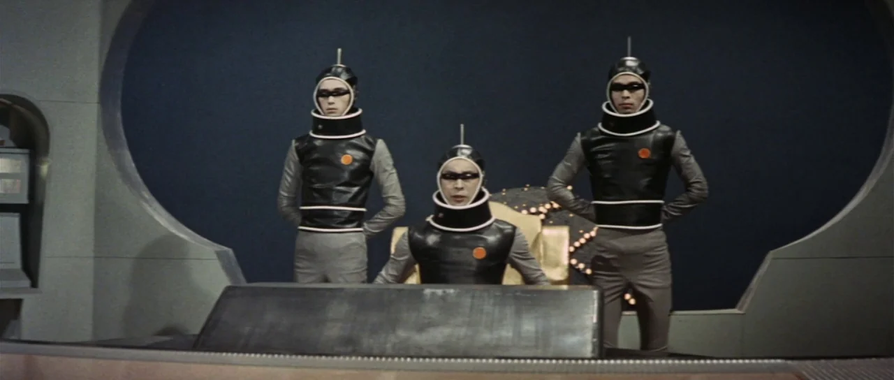 Invasion of Astro Monster (1965) movie still: medium — A 1960s science fiction spacecraft bridge features rounded structural elements and a dark…