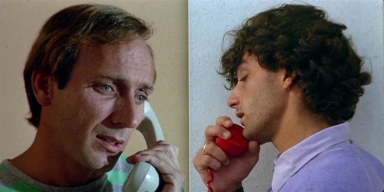 Law of Desire (1987) movie still: closeup — A split-screen composition shows two men in separate indoor environments speaking on telephones. The…