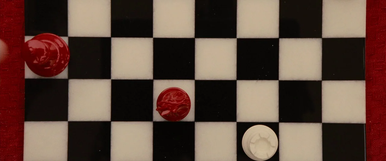 The Twilight Saga: Breaking Dawn – Part 1 (2011) movie still: closeup — A polished marble board with alternating black and white squares rests on a…