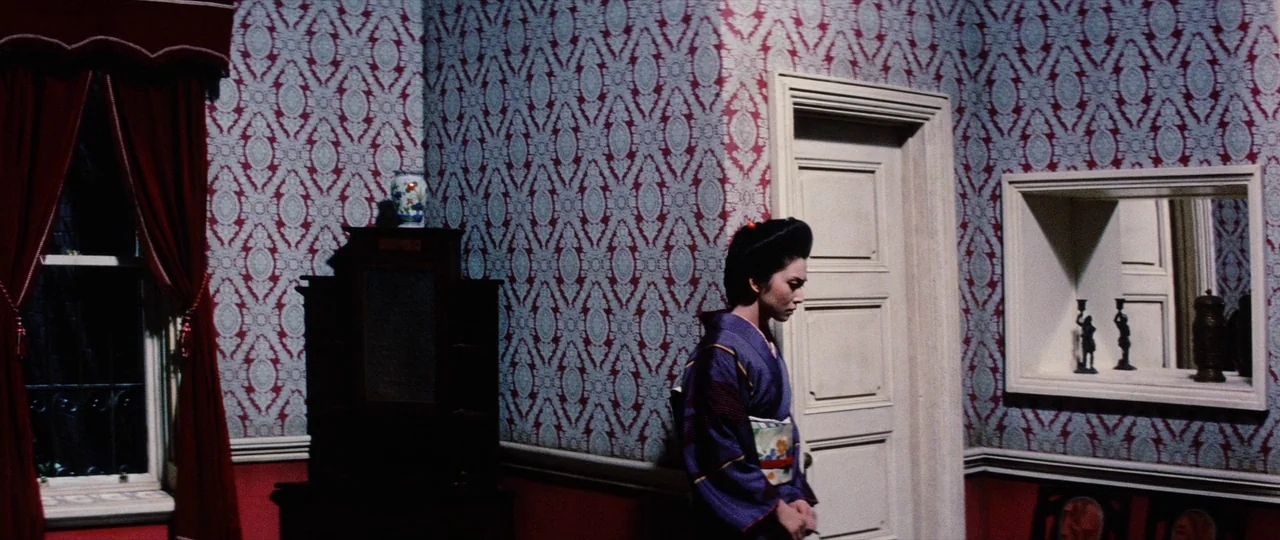 Lady Snowblood Song of Vengeance (1974) movie still: fullbody — A room features intricate red and white Victorian-style wallpaper and heavy dark…