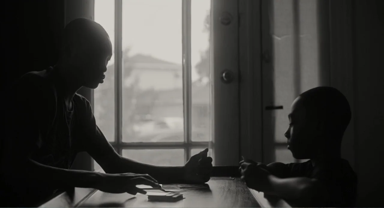What You Gonna Do When the World's on Fire? (2019) movie still: medium — An interior space features a table positioned before a large window with…