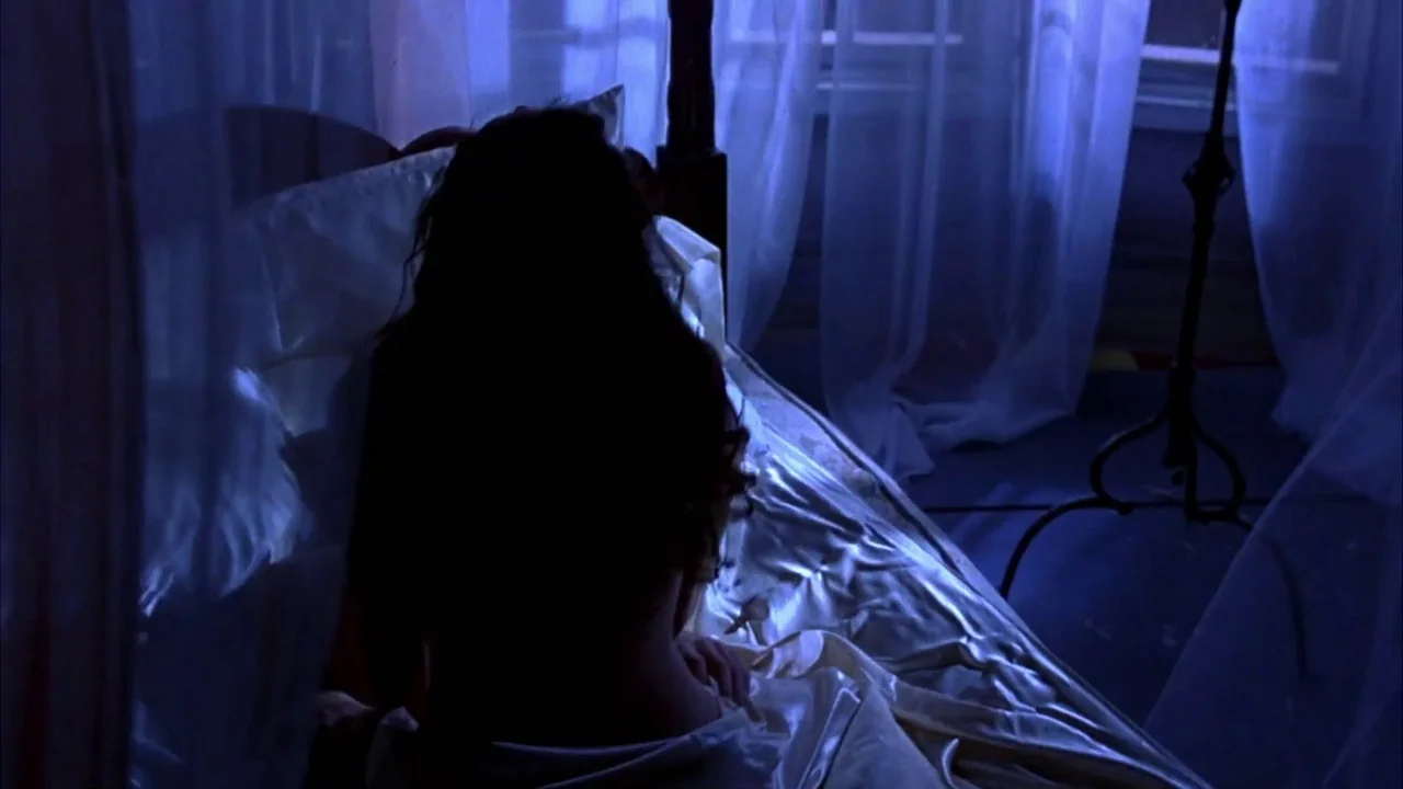 Hellraiser: Bloodline (1996) movie still: medium — A dark room illuminated by moonlight with sheer white curtains hanging over a window. A woman…