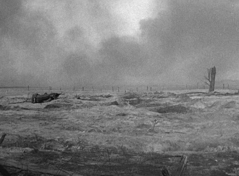 All Quiet on the Western Front (1930) movie still: establishing — A desolate, war-torn field features craters, mud, and scattered debris under a…