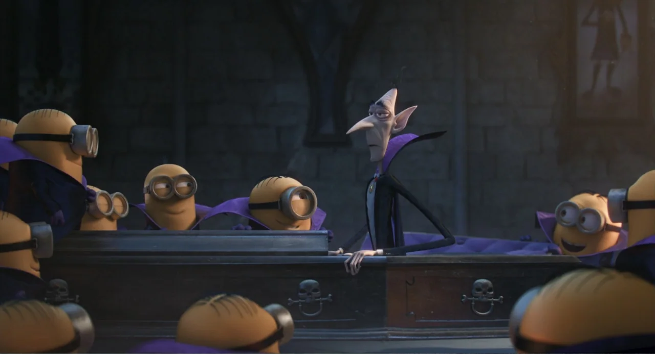 Minions (2015) movie still: medium — A stone crypt features a dark wooden coffin centered in the dim space. A tall, thin vampire stands behind the…