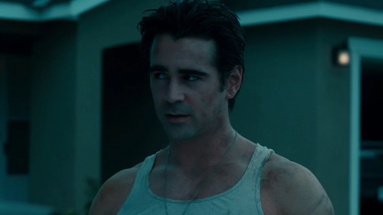 Fright Night (2011) movie still: medium — A man stands in front of a suburban home at night under cool lighting. He wears a ribbed undershirt and…