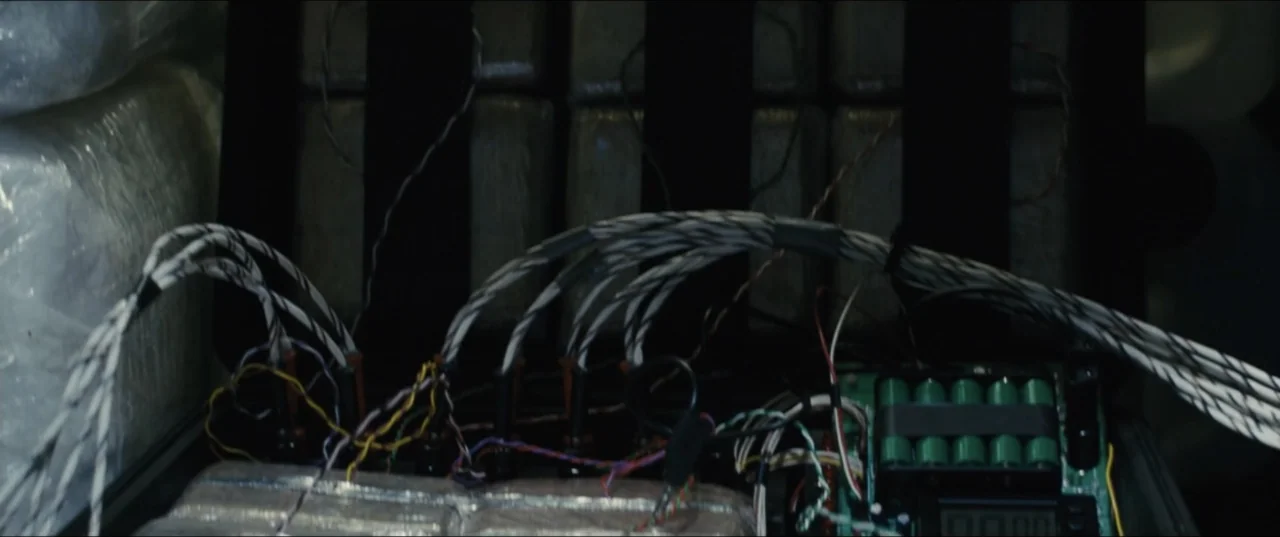 Jack Ryan: Shadow Recruit (2014) movie still: closeup — The interior of a dark metal container holds a homemade explosive device with wires. Bundles…
