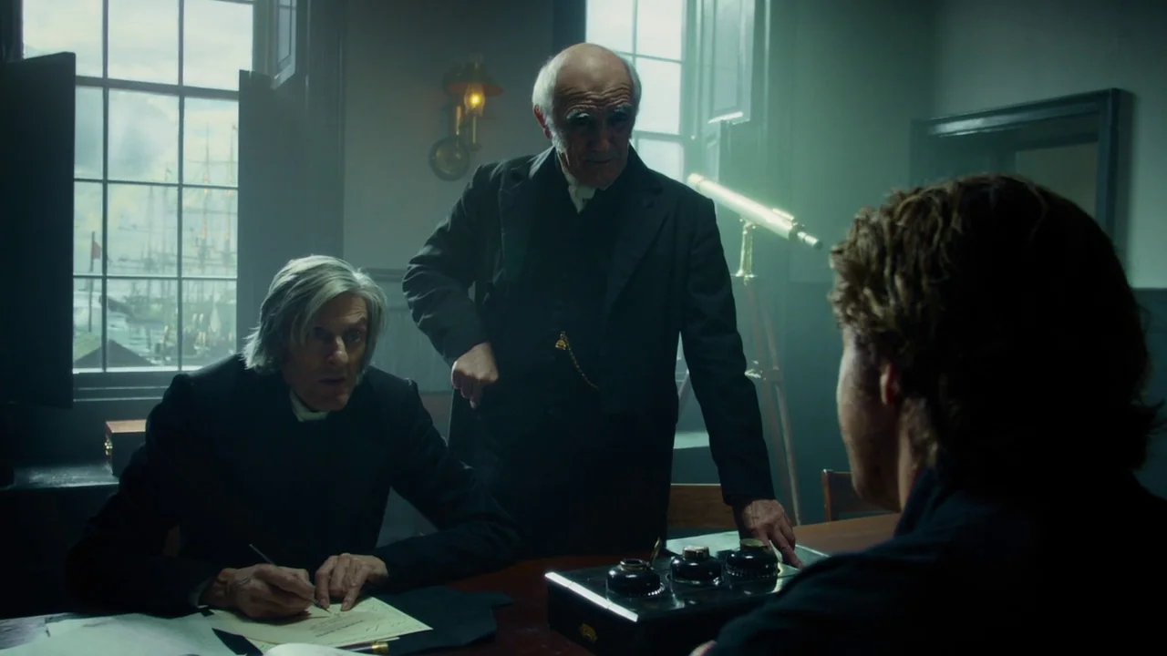 In The Heart of the Sea (2014) movie still: medium — A 19th-century study features large windows overlooking a harbor with tall sailing ships. Three…