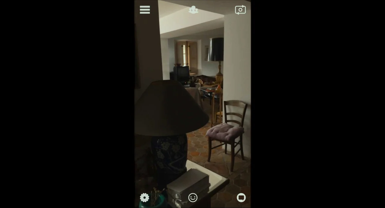 Happy End (2017) movie still: wide — A terracotta tiled floor transitions from a dark foreground to a brightly lit room. An empty wooden chair sits…