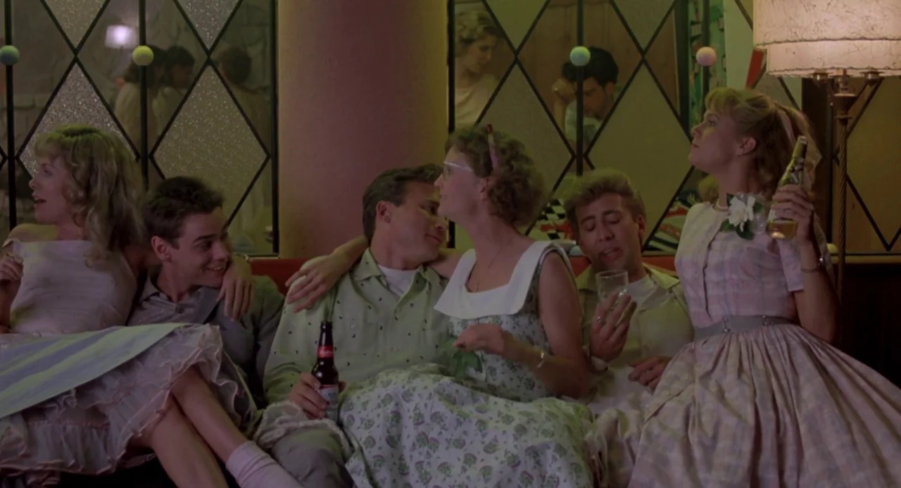 Peggy Sue Got Married (1986) movie still: medium — A 1950s-style restaurant booth features decorative diamond-shaped mirror panels on the wall…