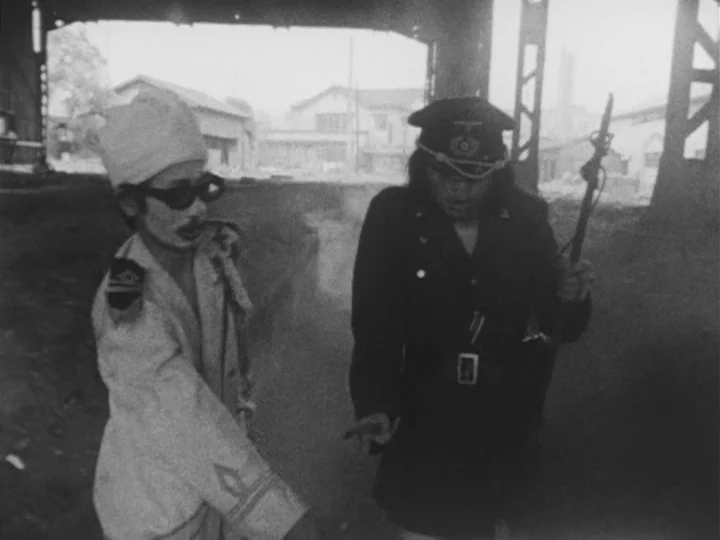 The War of Jan-Ken-Pon (1971) movie still: medium — A dark urban underpass with heavy structural girders creates a silhouette effect. Two…