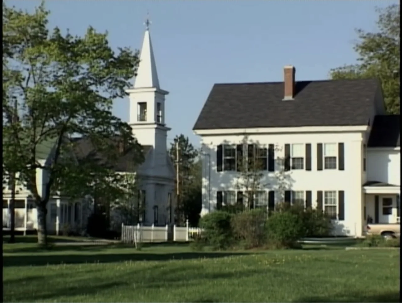 A Rape in a Small Town: The Florence Holway Story (2005) movie still: establishing — A rural street corner features a white church and an adjacent…