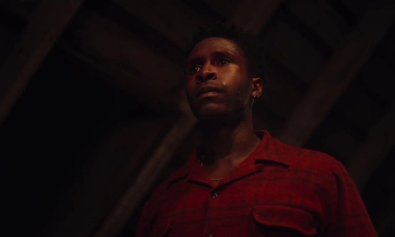 The Last Black Man in San Francisco (2019) movie still: medium — A dark, wood-paneled attic with exposed beams and deep shadows obscuring the…