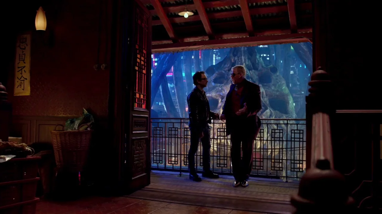 Pacific Rim (2013) movie still: fullbody — A dark wooden balcony with traditional geometric railings overlooks a futuristic neon-lit city street.…