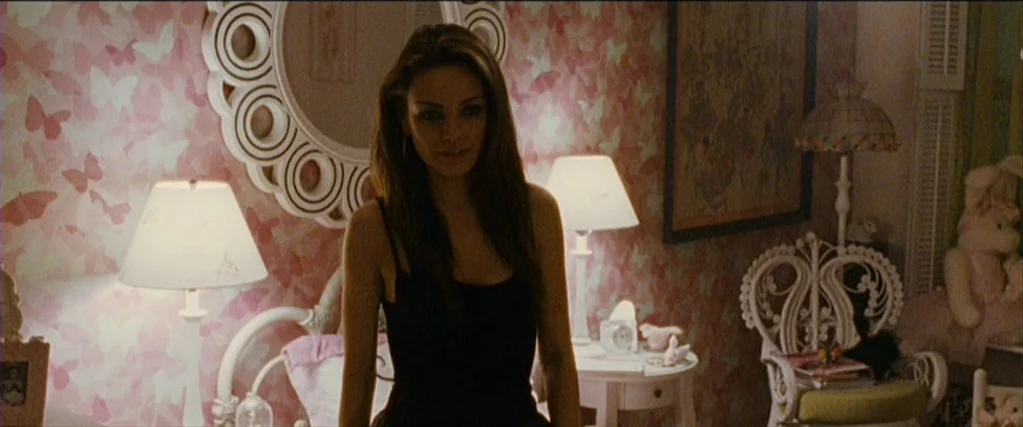 Black Swan (2010) movie still: medium — A room features pink butterfly-patterned wallpaper and vintage white wooden furniture. A woman stands in the…