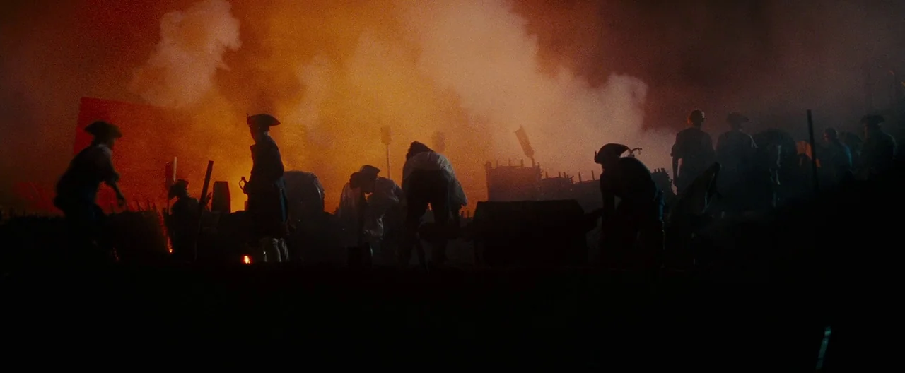The Last of the Mohicans (1992) movie still: wide — A field at night is filled with thick, orange-lit smoke during a conflict. Multiple figures in…