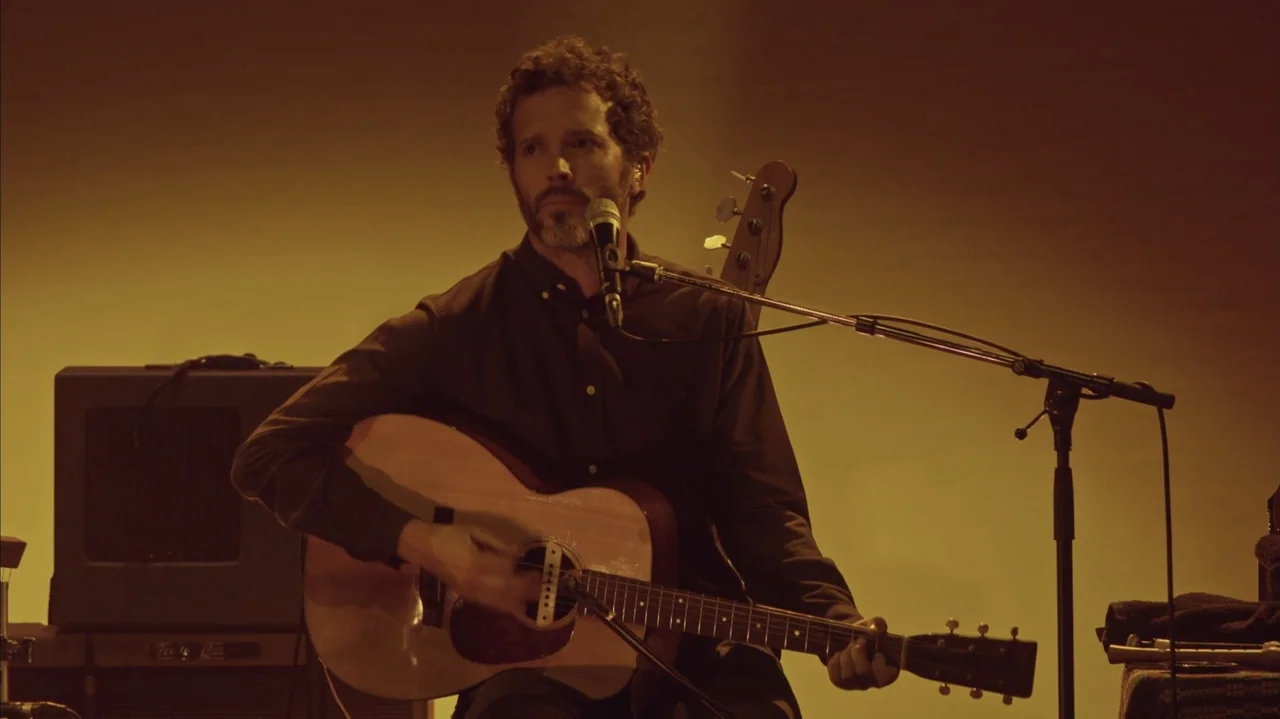 Flight of the Conchords: Live in London (2018) movie still: medium — A minimalist studio space with a warm monochromatic yellow background.