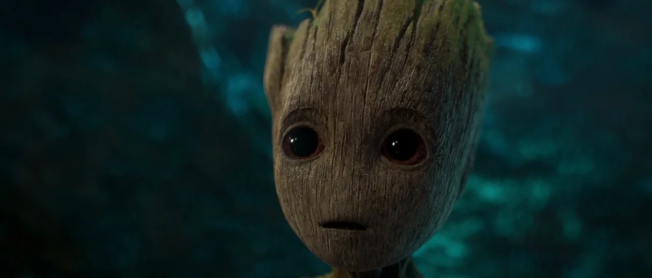 Guardians of the Galaxy Vol. 2 (2017) movie still: closeup — A dark, blurred environment with blue light cast on the bark-covered creature. The…