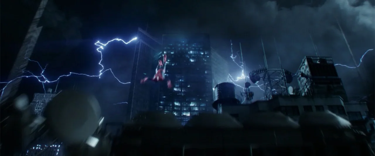 The Amazing Spider-Man 2 (2014) movie still: wide — A dark night urban skyline is illuminated by multiple lightning strikes above building tops. A…