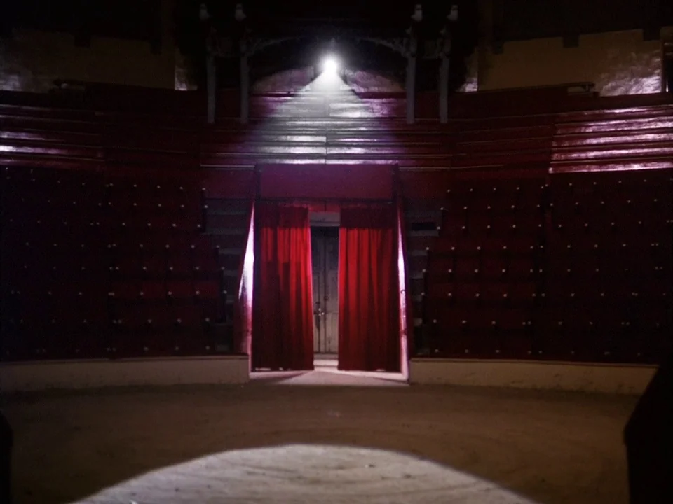 The Clowns (1970) movie still: wide — An empty circus ring features tiered red seating surrounding a central sandy performance area. A single…