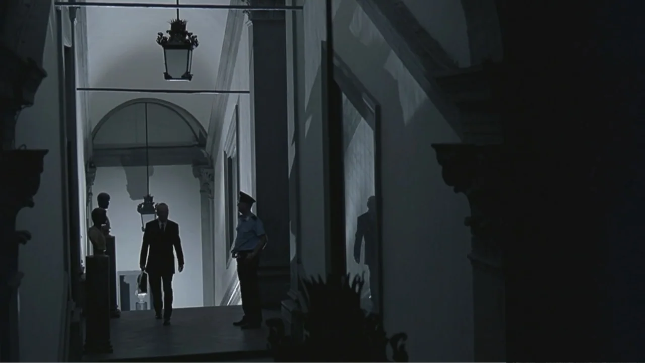 Hannibal (2001) movie still: medium — A stone-walled interior corridor features neoclassical architectural details and a decorative hanging lamp. A…