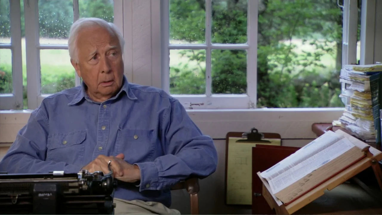 David McCullough: Painting with Words (2008) movie still: medium — A home office features a wooden desk placed in front of a white window. An…