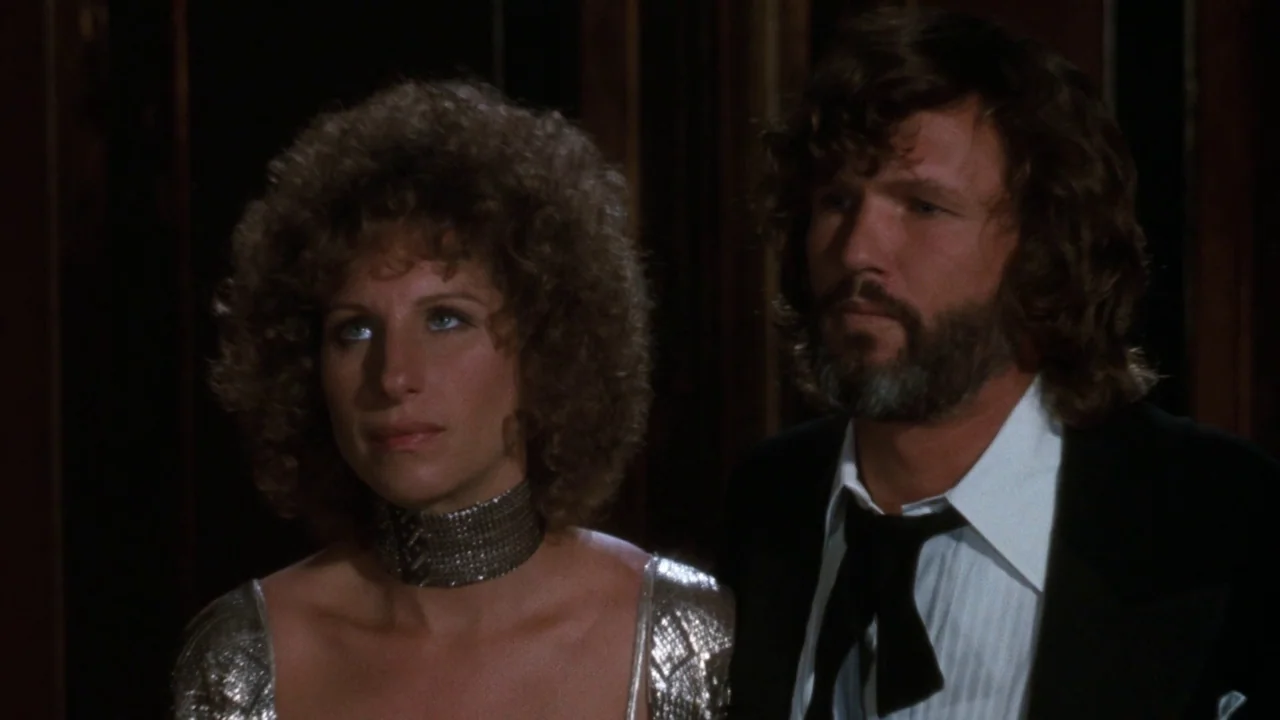 A Star Is Born (1976) movie still: medium — A woman and a man stand in a dark, dimly lit venue with wooden panels. They are both gazing off-screen…