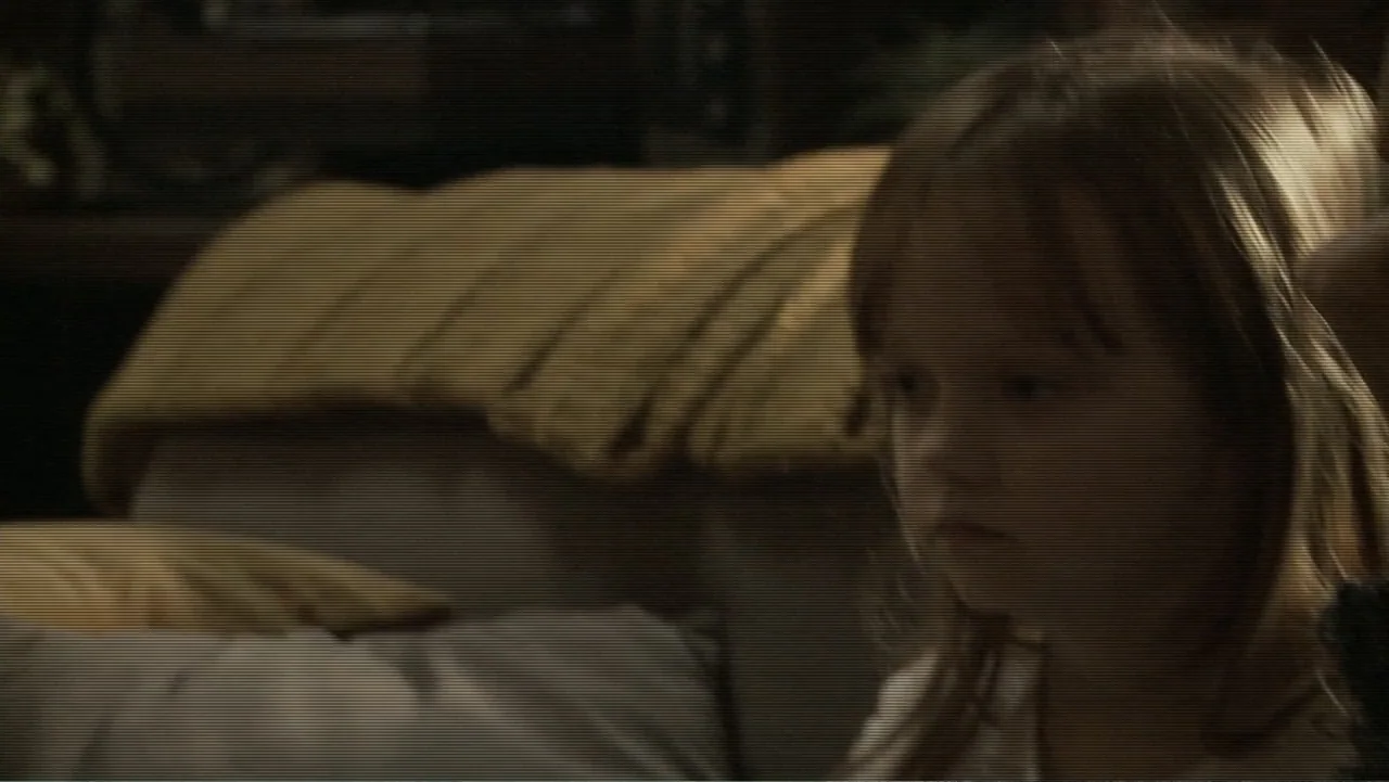 Paranormal Activity: The Ghost Dimension (2015) movie still: closeup — An interior space features soft furniture in the background. A young child…
