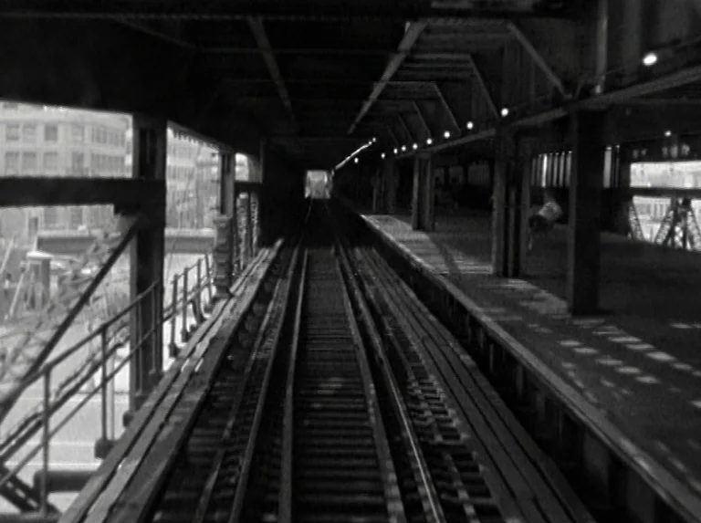 Alice in the Cities (1974) movie still: establishing — An elevated metropolitan railway track stretches into the distance through a steel-framed…