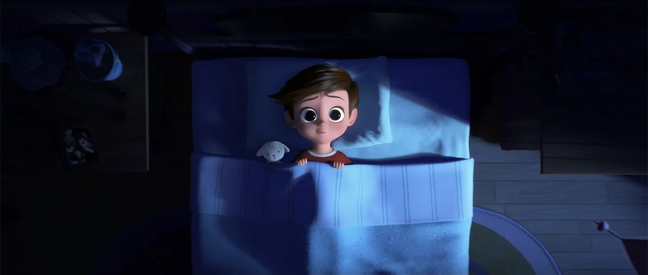 The Boss Baby (2017) movie still: medium — A bedroom at night features a small bed viewed from a high angle. A young boy lies under a blue blanket…