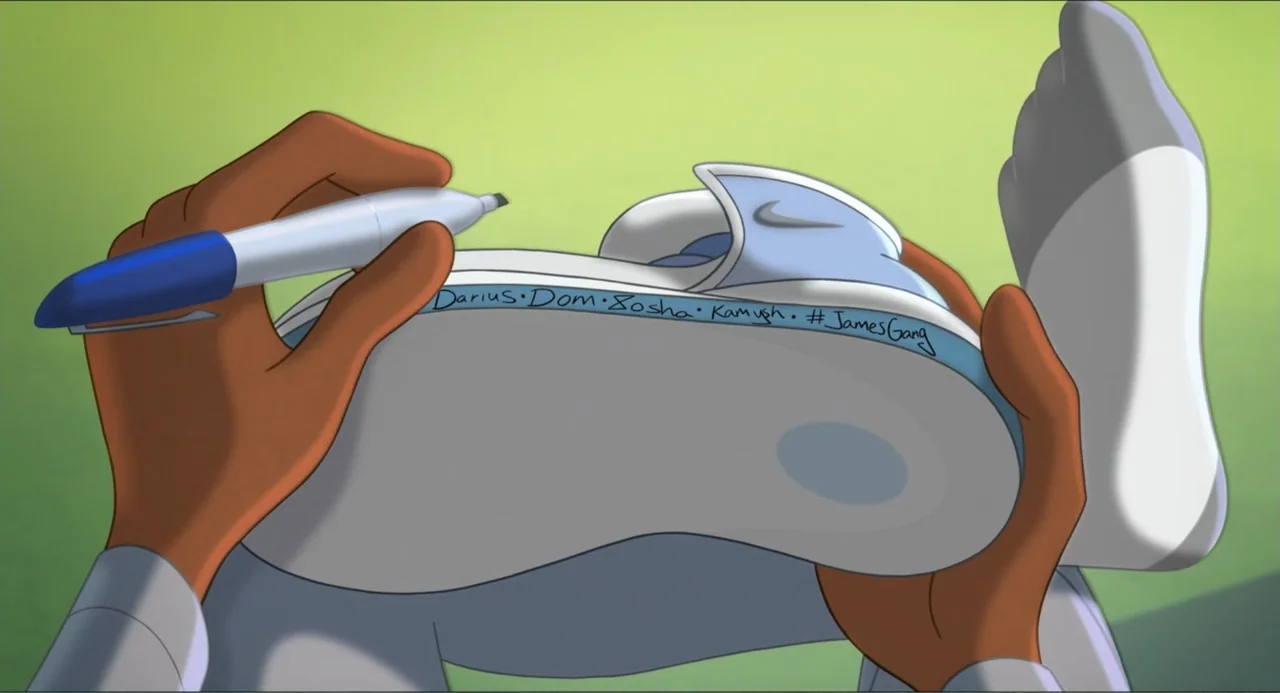Space Jam: A New Legacy (2021) movie still: closeup — A close-up view shows a person holding a light blue and white sneaker. A hand uses a blue…