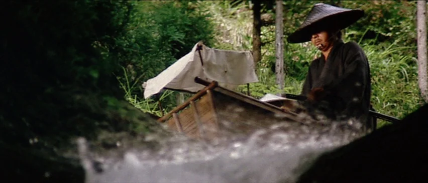 Lone Wolf and Cub: Baby Cart in the Land of Demons (1973) movie still: medium — A lush, green woodland setting with a small stream flowing in the…