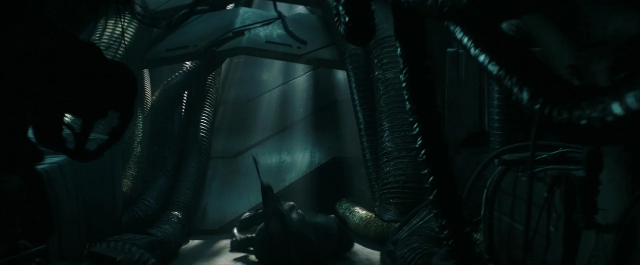 Pacific Rim: Uprising (2018) movie still: medium — A cramped industrial compartment is filled with ribbed air ventilation hoses and metallic…
