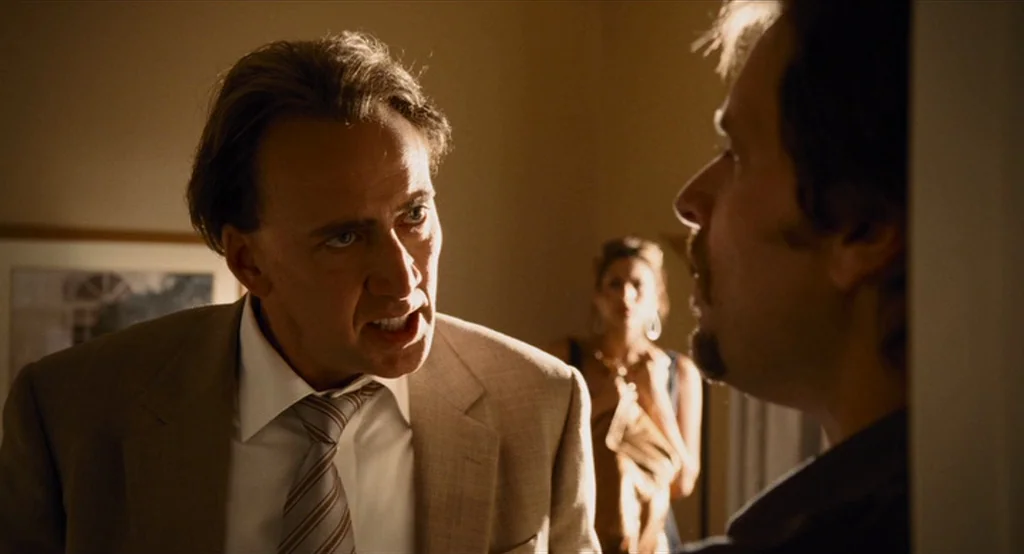Bad Lieutenant: Port Of Call New Orleans (2009) movie still: medium — An interior hotel setting features a man in a tan suit confronting another…