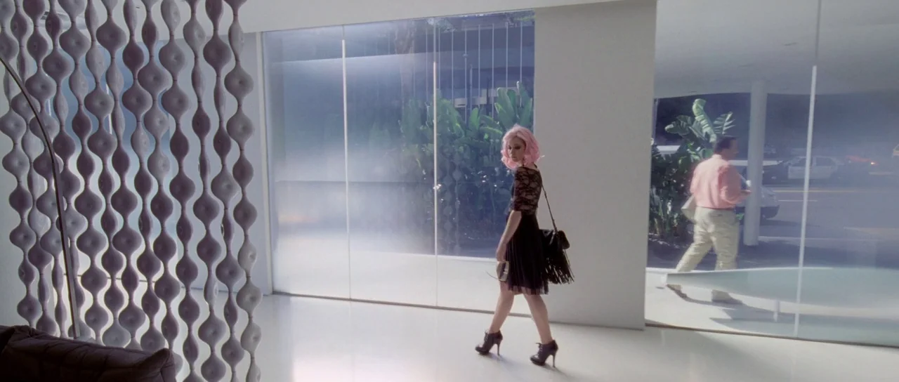Knight of Cups (2015) movie still: fullbody — A modern minimalist interior features white polished floors, large frosted glass panes, and sculptural…