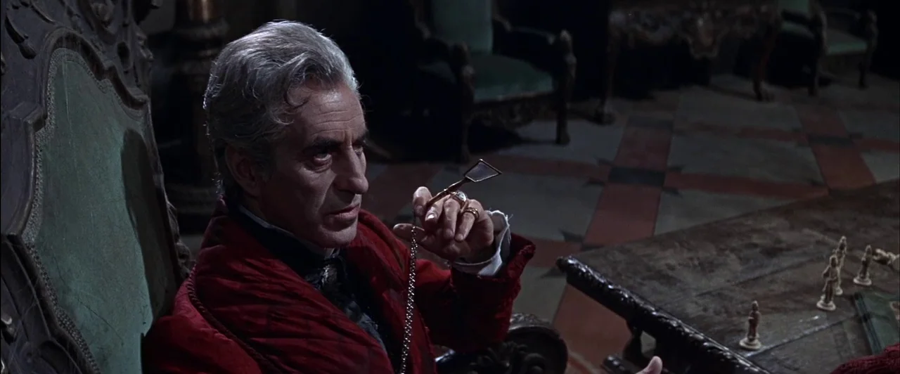 The Fearless Vampire Killers (1967) movie still: medium — An ornate wood-paneled room contains antique green velvet chairs and a chess board setup.…
