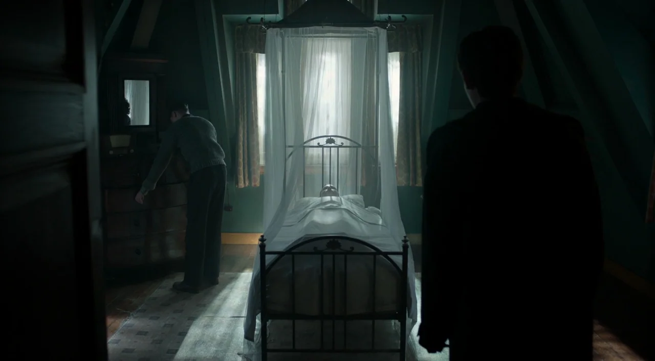 Miss Peregrine’s Home for Peculiar Children (2016) movie still: wide — A dimly lit attic room features a central metal bed with a translucent…
