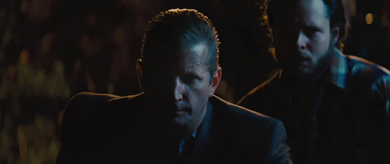 Mud (2012) movie still: medium — An outdoor location at night with darkness surrounding the two figures. Two men stand in close proximity while…