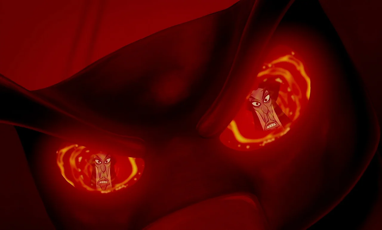 Aladdin (1992) movie still: closeup — A dark abstract form features two glowing red circular openings resembling eyes. A man's face is mirrored…