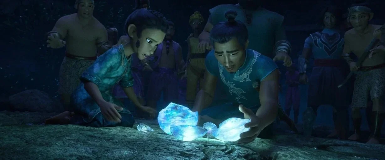 Raya and the Last Dragon (2021) movie still: medium — A group of people gathers in a dark, rocky outdoor setting at night. A man and a young woman…
