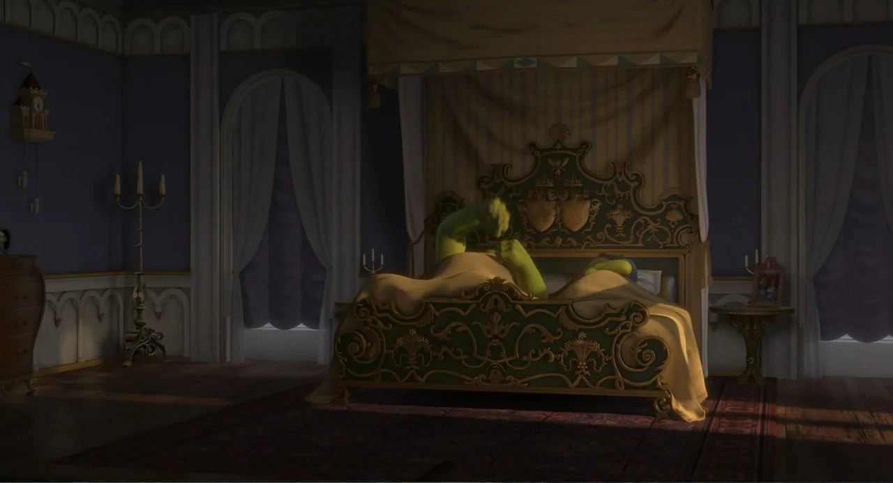 Shrek the Third (2007) movie still: wide — An ornate, royal-style bedroom features a large, carved green and gold wooden bed frame. Two ogres are…