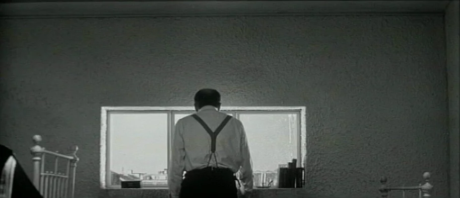 And The Fifth Horseman is Fear (1965) movie still: medium — A spare, austere room features a textured wall and a single window overlooking…