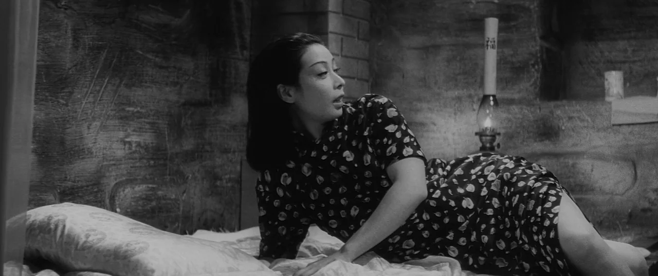The Human Condition I: No Greater Love (1959) movie still: medium — A rustic stone-walled room with a dimly lit kerosene lamp in the background. A…